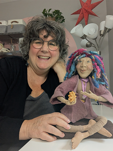 Artist Stacy Vajta with a handmade spirit doll at Sacred Art & Story
