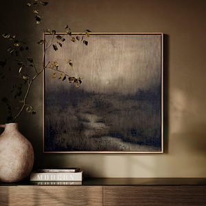 Original charcoal and soft pastel artwork by Linsey Gray displayed in moody lighting against a golden moss colored wall above a walnut console cabinet, styled with a large autumn tree limb in a ceramic vase and a stack of design books to the left of the artwork. 